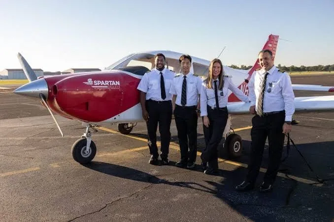Flight training students beside a training aircraft